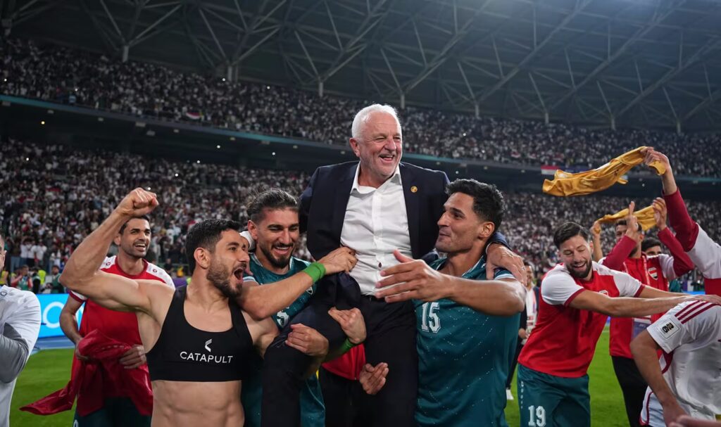 Graham-Arnold-celebrates-a-FIFA-World-Cup-2026-qualifying-win-with-his-Iraq-players-1024x607